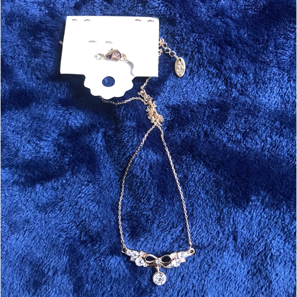 NWT Crystal Drop Gold toned Necklace with Bow Accent